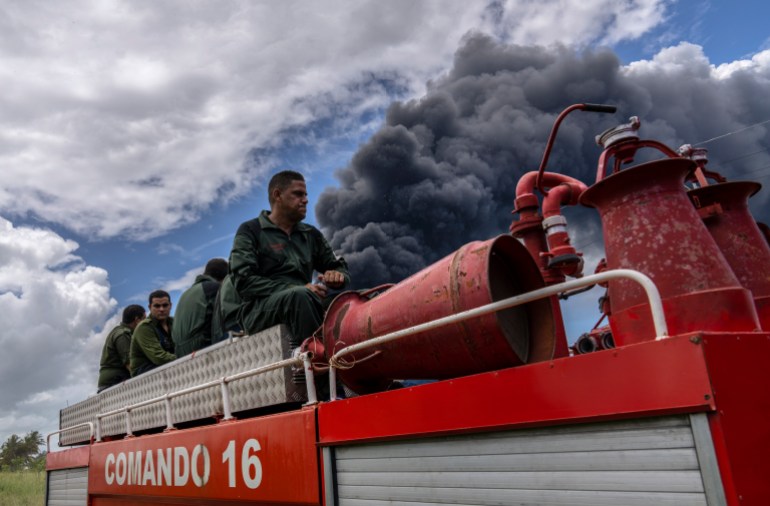 Firefighters move in a truck inside the Matanzas supertanker base to douse a fire that started during a thunderstorm, in Matanzas, Cuba