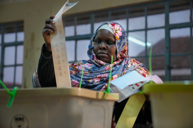 A woman casts her ballot at the Kibera primary school in Nairobi