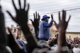 Presidential candidate Raila Odinga waves to his supporters after casting his vote at the Kibera Primary School in Nairobi, Kenya [Mosa&#39;ab Elshamy/The Associated Press]