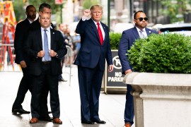 Former President Donald Trump gestures as he departs from Trump Tower [File: Julia Nikhinson/AP Photo]
