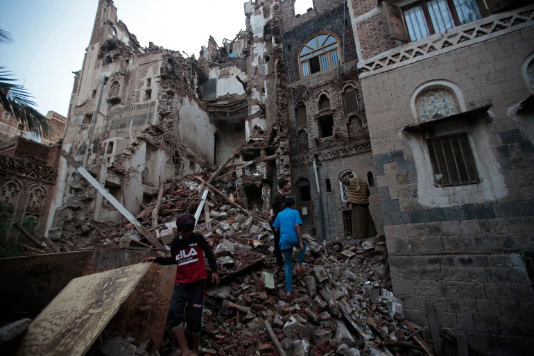 Yemeni people inspect a UNESCO-listed building that collapsed due to rain in the ancient city of Sanaa, Yemen.