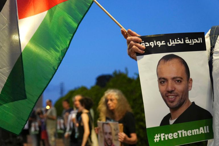 Protesters gather outside the hospital where Palestinian Khalil Awawdeh is clinging to life in Be'er Yaakov on Aug. 13, 2022 [Tsafrir Abayov/AP]