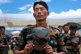 A Naga Army soldier stands in prayer during celebrations