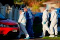 New Zealand police investigators in Auckland on Aug. 11, 2022, after bodies were discovered in suitcases [Dean Purcell/New Zealand Herald via AP]