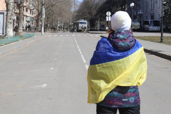 A woman wearing a Ukrainian flag is seen in Kherson, Ukraine.