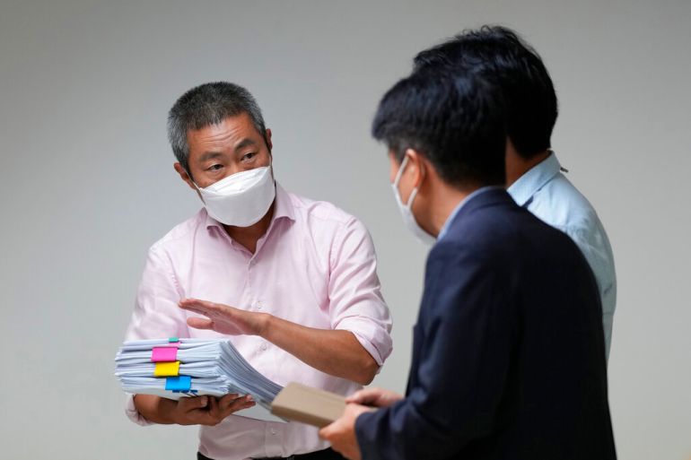 Peter Møller, attorney and co-head of the Danish Korean Rights Group, holds documents at the Truth and Reconciliation Commission in Seoul, South Korea on Tuesday, August 23, 2022 [Lee Jin-man/AP]