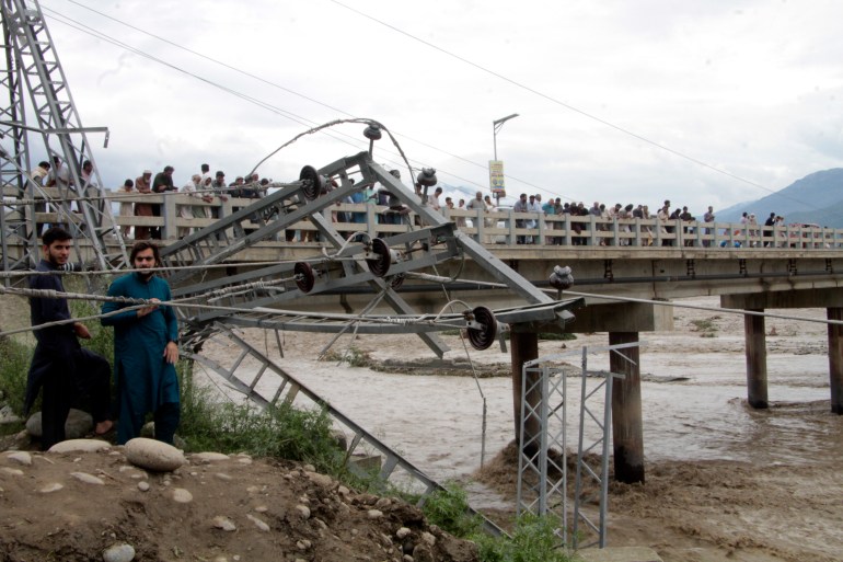 Damaged electrical towers on the ground after being damaged during the floods in Mingora.