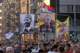 People display the images of Russian President Vladimir Putin, center, and controversial Serb World War II leader Gen. Dragoljub Draza Mihailovic, left, during a protest against the international LGBT event EuroPride in Belgrade