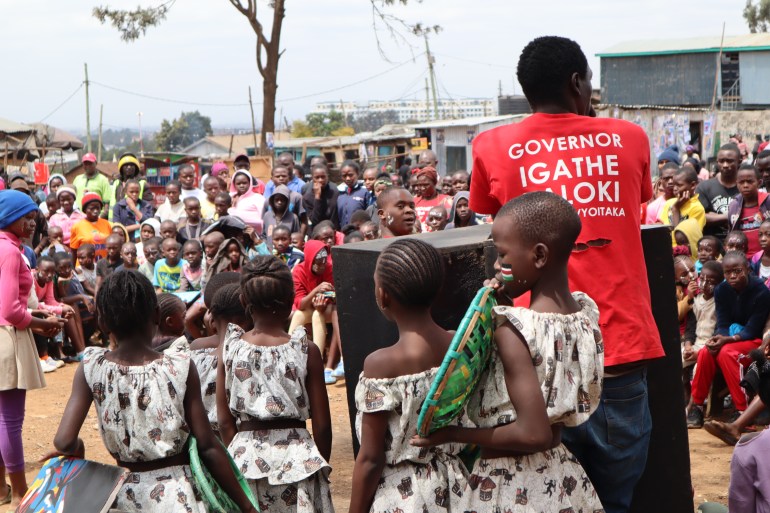 Children prepare for their performance at a peace initiative in Kibera