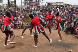 Dancers perform for the crowd at a peace initiative in Kibera