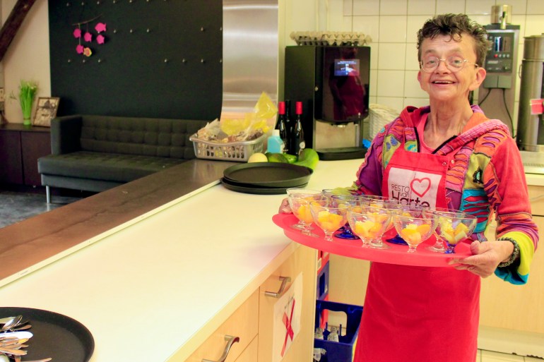 A photo of Hanny Heuvelink holding bowls of cut fruit.