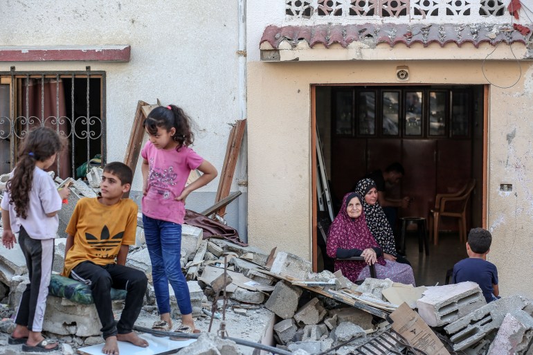 Nadia Shamallkh at her destroyed home in Gaza [Abdelhakim Abu Riash/Al Jazeera]