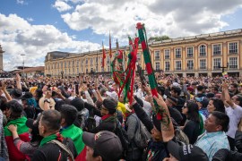 Indigenous Nasa held up their bastons in celebration of President Gustavo Petro&#39;s inauguration on August 7, 2022 [Christina Noriega/Al Jazeera]