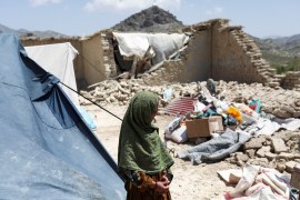 An Afghan girl stands near what was once her house, destroyed by an earthquake in June, in Afghanistan&#39;s Paktika province [Reuters]
