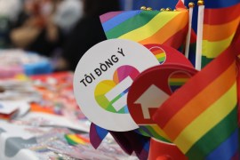 Rainbow flags and LGBTQ campaigning symbols on a table