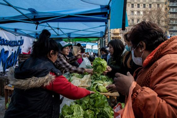 Shoppers purchase groceries at a market hosted by the Union of Popular Economic Workers (UTEP) in front of the National Congress building in Buenos Aires, Argentina