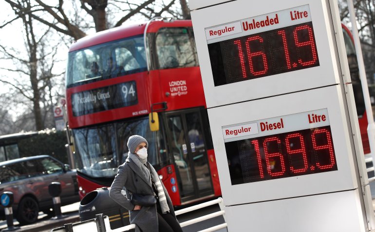 Increased petrol and diesel prices are seen on a display board at a filling station, in London, Britain
