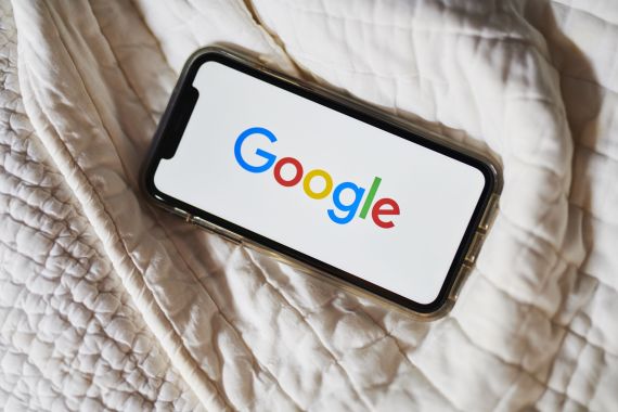 The Google Inc. logo is displayed on an Apple Inc. iPhone in this arranged photograph taken in Little Falls, New Jersey, U.S
