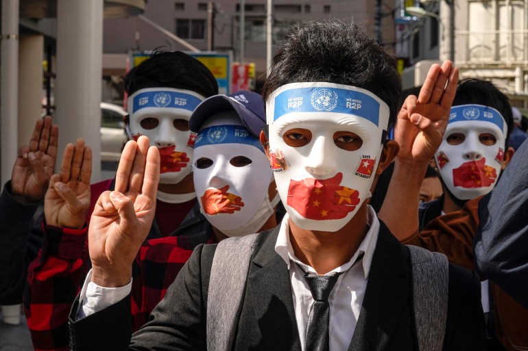 Myanmar residents in Japan hold a protest in Tokyo against the coup wearing white masks