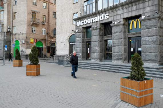 A man walks past a closed McDonald's restaurant in central Kyiv, Ukraine