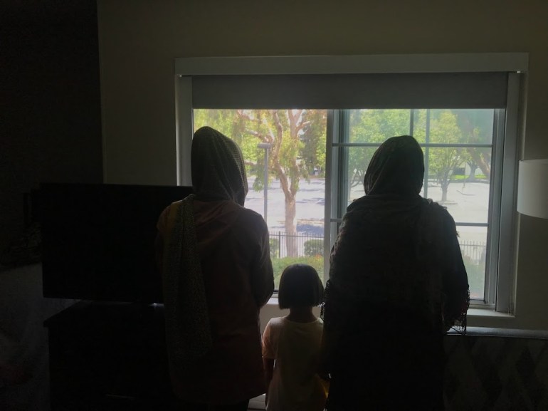 Afghan Family stands in shadow at California hotel