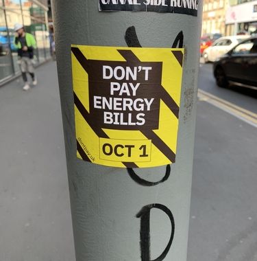 A sticker on a pole in Manchester, UK, protesting rising energy bills.