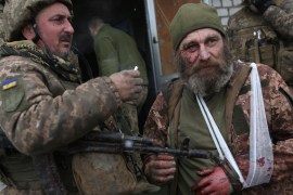 A wounded servicemen of Ukrainian Military Forces looks on after the battle with Russian troops and Russia-backed separatists in Luhansk region on March 8, 2022. - The number of refugees flooding across Ukraine's borders to escape towns devastated by shelling and air strikes passed two million, in Europe's fastest-growing refugee crisis since World War II, according to the United Nations.