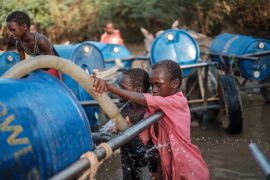 Children fill water tanks in a private pump near the Shabelle river in the city of Gode, Ethiopia