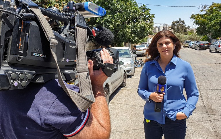 This handout file picture obtained from a former colleague of Al-Jazeera's late veteran TV journalist Shireen Abu Aqleh (Akleh), shows her reporting for the Qatar-based news channel from Jerusalem on May 22, 2021.