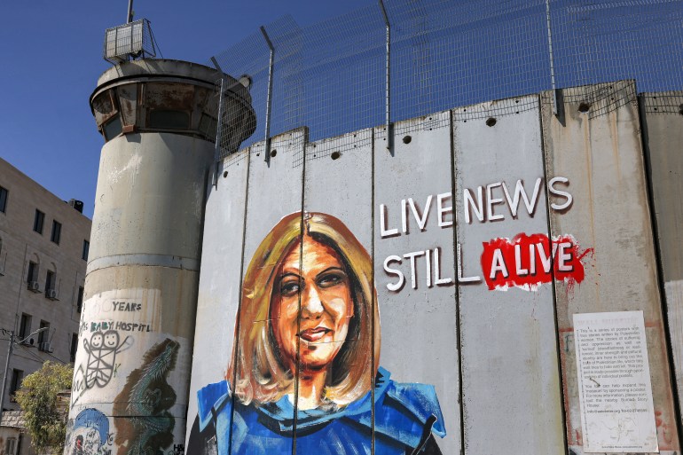 This picture taken on July 6, 2022 shows a mural depicting slain Al Jazeera journalist Shireen Abu Akleh, who was killed while covering an Israeli army raid in Jenin in May, drawn along Israel's controversial separation barrier in the biblical city of Bethlehem in the occupied West Bank.