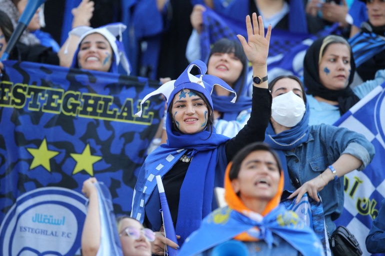 Iranian women fans of Esteghlal football club cheer during a match between Esteghlal and Mes Kerman at the Azadi stadium in the capital Tehran, on August 25, 2022.
