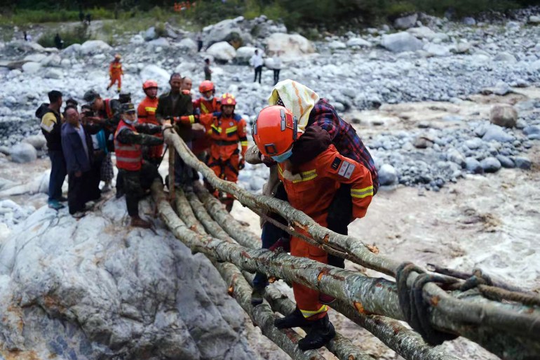 Rescue workers evacuate residents after an earthquake in Luding county in China's southwestern Sichuan province.