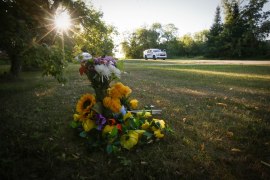 Flowers sit outside the house of one of the stabbing victims in Saskatchewan, Canada