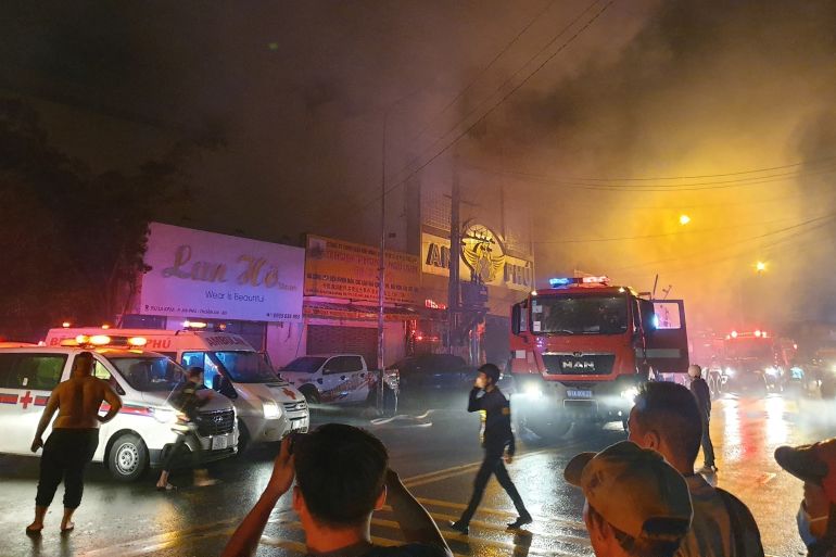 Firefighters at the scene of a deadly fire that engulfed a karaoke bar north of Ho Chi Minh City on September 6, 2022 [Vietnam News Agency/AFP]