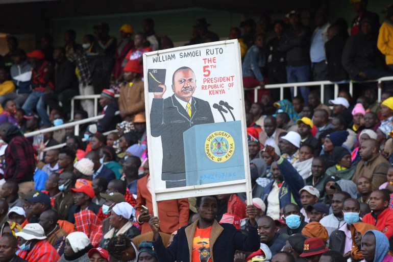 Supporters of Kenya President elect William Ruto hold a painting depicting him at the Moi International Sports Center Kasarani in Nairobi