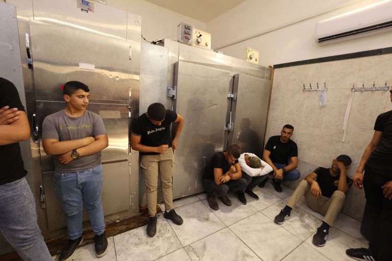 Friends and relatives mourn the death of Palestinian Uday Salah, 17, reportedly killed during clashes with Israeli forces, at the Jenin hospital morgue, in the occupied West Bank, on September 15, 2022.