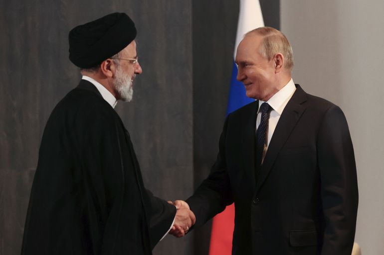 Russian President Vladimir Putin meets with his Iranian counterpart Ebrahim Rais