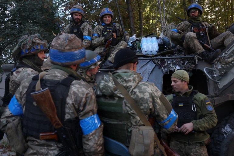 Ukrainian soldiers have a break on their way to the frontline against Russian troops in the Donetsk region