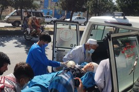Relatives and medical staff move a wounded girl from an ambulance outside a hospital in Kabul following a suicide bombing at a learning centre in the Dasht-e-Barchi area of the Afghan capital [AFP]