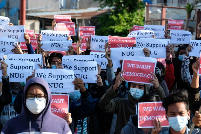 Protesters in Myanmar's Shan State carrying signs saying 'We Support NUG'