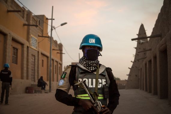 Policemen of the United Nations Stabilisation Mission in Mali (MINUSMA), patrol in front on the Great Mosque in Timbuktu, on December 8, 2021