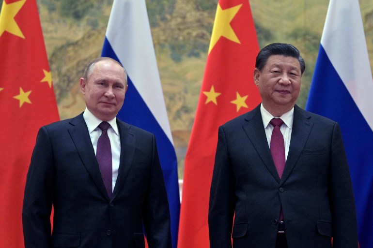 Russian President Vladimir Putin (L) and Chinese President Xi Jinping pose during their meeting in Beijing, on February 4, 2022. (Photo by Alexei Druzhinin / Sputnik / AFP)