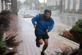 A man tries to run amid the wind and rain of Hurricane Ian in Sarasota, Florida.
