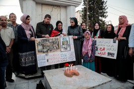 Every year, Rehab Kanaan (centre) lights candles in memory of the victims of the Sabra and Shatila massacre [Abdelhakim Abu Riash/Al Jazeera]