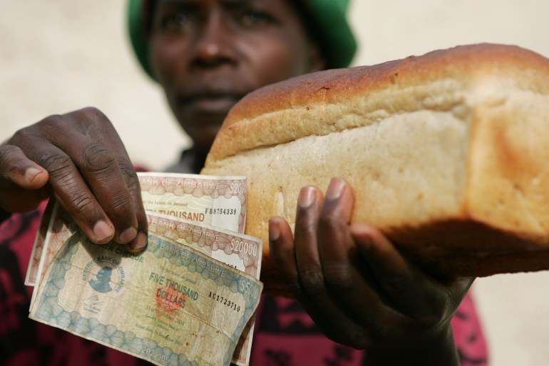 A Zimbabwean woman holds a loaf of white bread