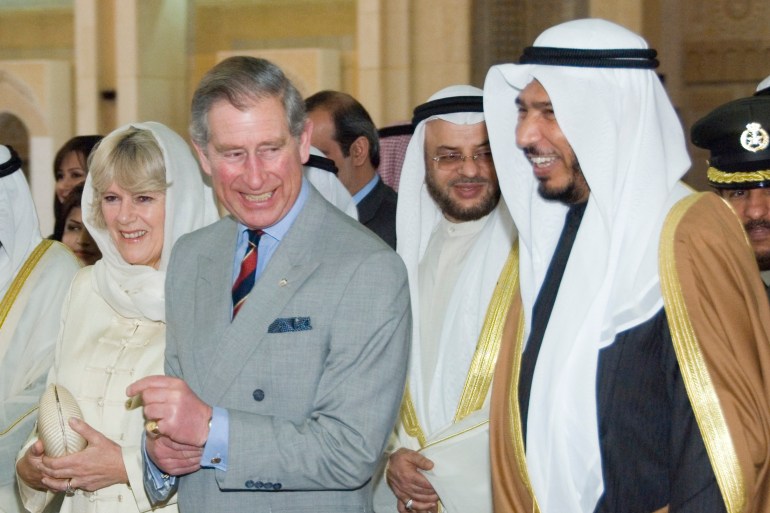 Prince Charles and his wife, Duchess of Cornwall, Camilla, walk with Kuwait Minister of Awkaf