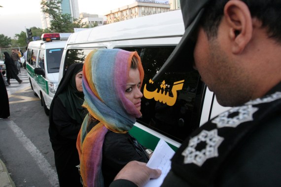 Morality police take down the name of a detained woman during a crackdown on "social corruption" in north Tehran in 2008