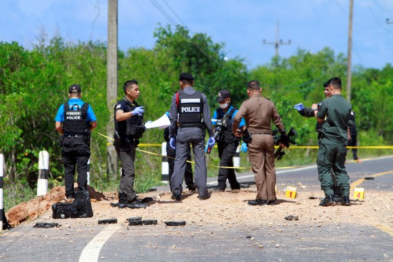 Police check the site of a roadside bomb explosion in Pattani province, Thailand, in 2018 [Surapan Boonthanom/Reuters]
