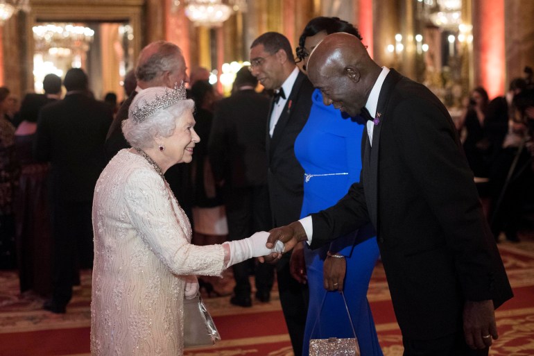 Queen Elizabeth II greets Keith Rowley, Prime Minister of Trinidad and Tobago, in the Blue Drawing Room at Buckingham Palace in London as she hosts a dinner during the Commonwealth Heads of Government Meeting, April 19, 2018.