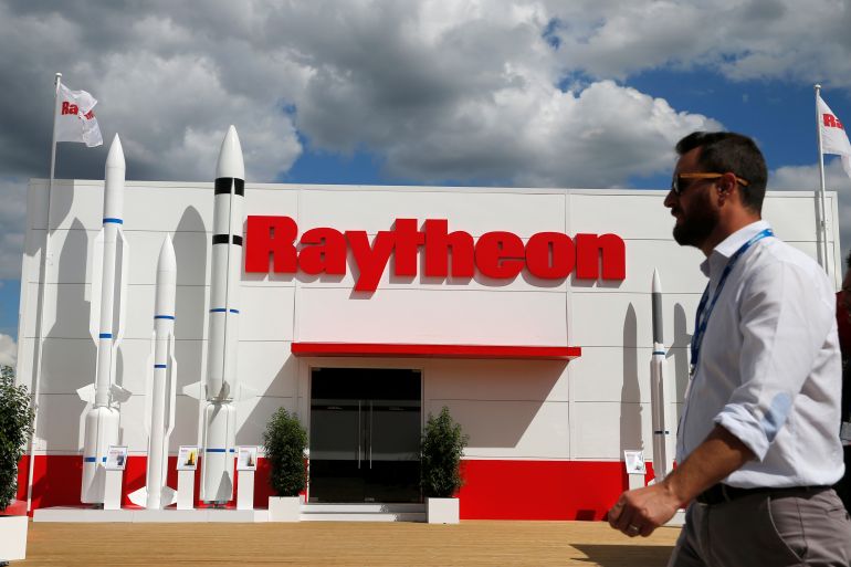 A visitor walks past Raytheon stand at the 53rd International Paris Air Show at Le Bourget Airport near Paris, France in 2019 [Pascal Rossignol/Reuters]